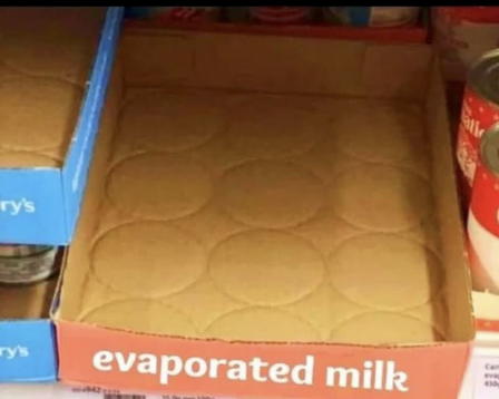 A photo depicting an empty cardboard tray labeled "evaporated milk".