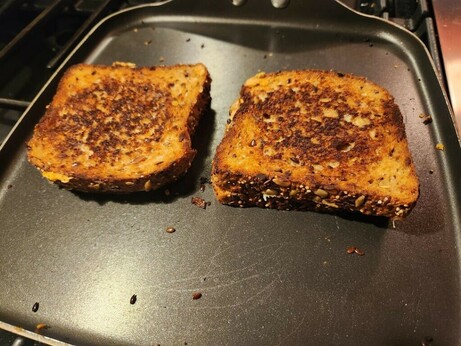 Five cheese grilled cheese with crushed red pepper flakes on Dave's Killer Bread.