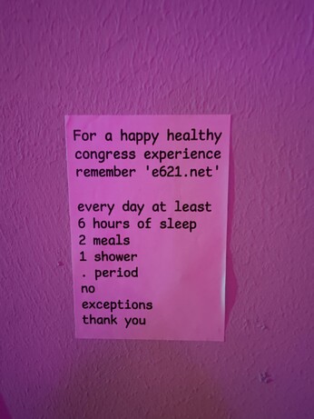 A sticker saying "For a happy healthy congress experience remember e621.net

every day at least
6 hours of sleep
2 meals
1 shower
period
no
exceptions 
thank you"