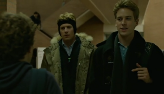 A scene from the movie where the twins approach Zuckerberg in a hallway to pitch him their website idea.