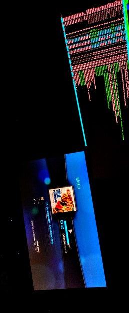 This photographic composition shot in total darkness shows two IPS LED panels side by side. The top screen displays a terminal window with a black background and colorful text, predominantly in red and green, with some blue elements. The text appears to be a log or output from a command-line interface, with various lines of code or data. The bottom screen shows a music player interface with a blue background. The interface displays the title "TRUE Romance" by Tomarke, with a progress bar indicating the song's playback status. The song is "10. Soundgarden - Outshined" from the album "Mediævæl." The screen also shows the time "00:05:12" and a volume control slider. The word "Music" is visible on the right side of the screen.

 Ovis2-8B

🌱 Energy used: 0.203 Wh