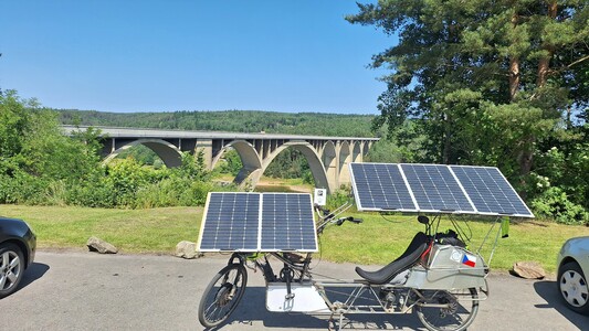 Solar recumbent bike parked in front of the Podolský bridge view in Southern Bohemia.
