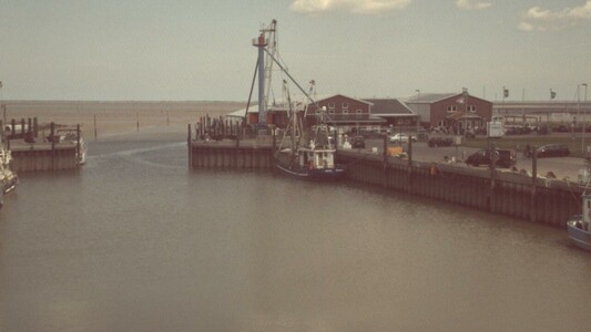 Foto of a docked fisher boat near wadden sea
