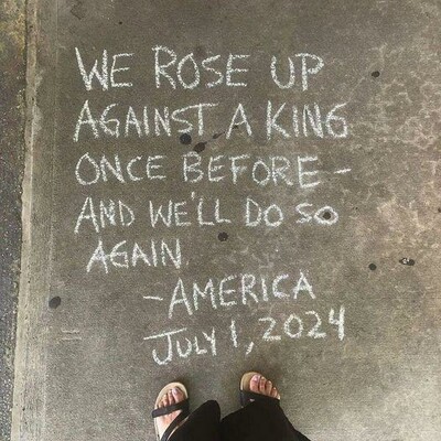 written in chalk on sidewalk at the toes of a woman with sandals
We rose up against a king once before - and we'll do so again
-America July 1, 2024