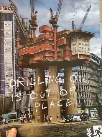 A picture of Oslo city with an oil platform photoshopped on top.
"Drilling oil is out of place" has been written with a white marker on top of the picture.