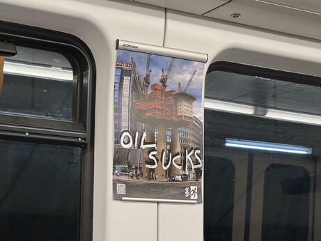 The same photoshopped picture of Oslo City, with "oil sucks" written on top both in black and white.