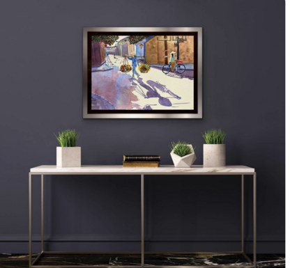 Framed art hung in display room.