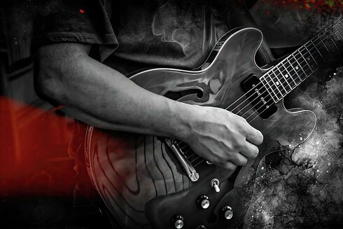 Close-up of a young rock guitarist in black and white, playing an electric guitar during a live performance, with dramatic lighting and a red light leak showcasing the energy and excitement of the performance.  From the Fine Art Gallery of Shelia Hunt.